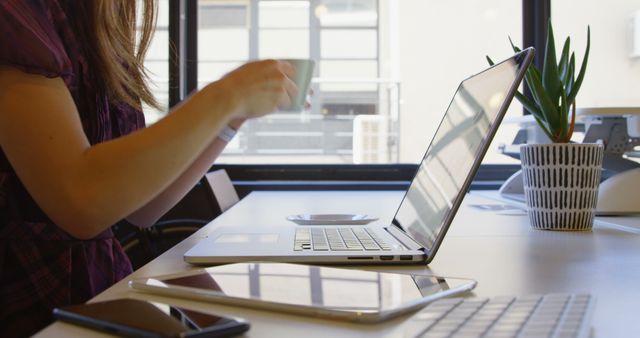 Young Businesswoman Using Mobile Phone and Drinking Coffee in Office - Download Free Stock Images Pikwizard.com