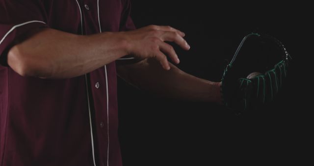 Baseball Pitcher Holding Glove Ready for Catch in Dark Background - Download Free Stock Images Pikwizard.com