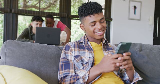 Happy Teenage Boy Using Smartphone in Living Room - Download Free Stock Images Pikwizard.com