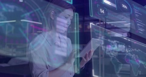 Midadult asian woman interacting with holographic data visualizations on tablet in office