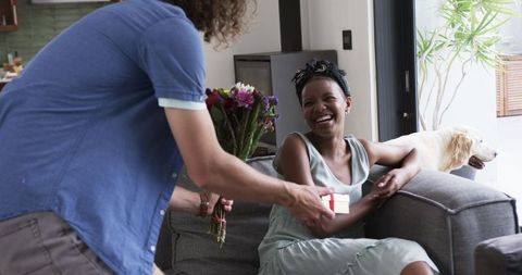 Happy Woman Receiving Surprise Flowers and Gift from Partner at Home - Download Free Stock Images Pikwizard.com