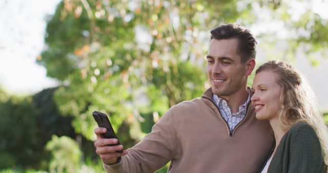 Image of happy caucasian husband and wife taking selfie smartphone in garden - Download Free Stock Photos Pikwizard.com