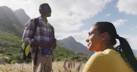 Couple Enjoying Mountain Trekking Adventure on Sunny Day
