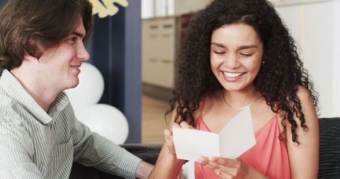 Happy Couple Celebrating Anniversary at Home with Gifts and Smiles