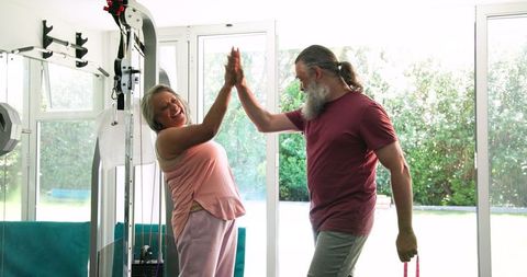 Active Senior Couple Enjoys Home Workout Using Resistance Bands