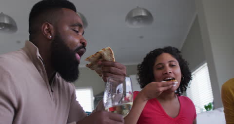 Friends Enjoying Pizza and Wine Gathering at Home