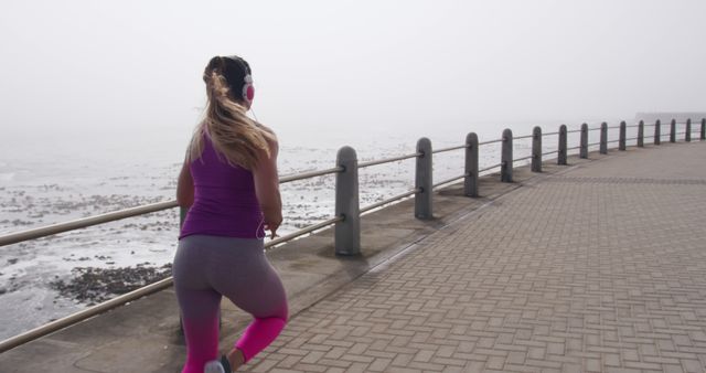 Woman Jogging on Overcast Day near Waterfront - Download Free Stock Images Pikwizard.com