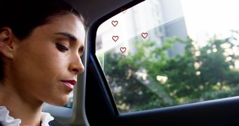 Woman reflecting during taxi ride with heart symbol overlays