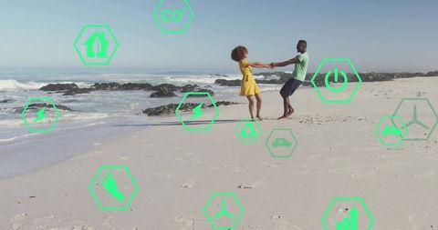 Joyful Couple Twirling on Seaside Beach with Eco Icons Overlay