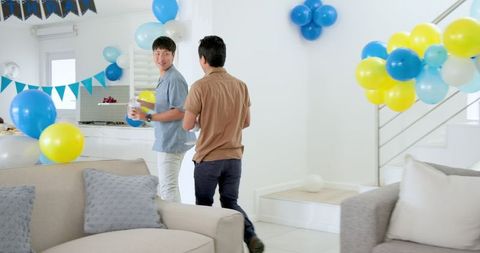Father and Son Entering Decorated Room with Joyful Celebration Vibes