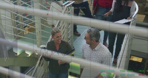 Corporate Team Discussing Stock Market Trends on Staircase