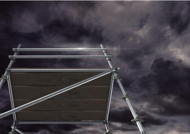 This construction-themed image shows scaffolding reaching into a dark stormy sky filled with dramatic clouds. Ideal for themes related to construction, engineering, or weather challenges. It can be used in presentations, articles, or advertisements emphasizing complex projects requiring strength and perseverance against daunting conditions.
