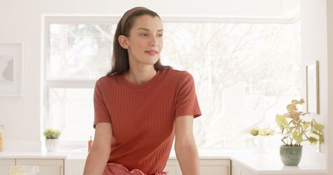 Contemplative Woman Relaxed in Modern Kitchen Setting