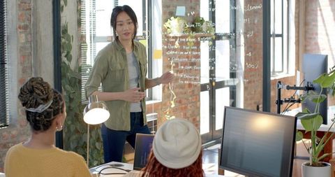 Diverse Female Team Collaborating in Modern Industrial Office Setting