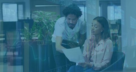 Business Colleagues Collaborating with Technology in Modern Office Lounge