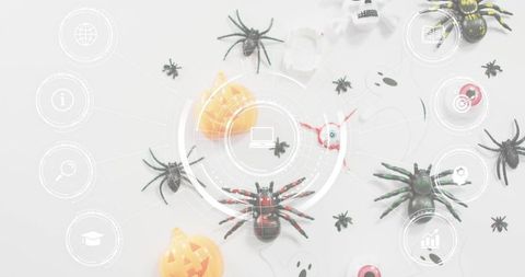 Halloween flatlay featuring red-accented black spider centered with pumpkin, eyeballs and hud