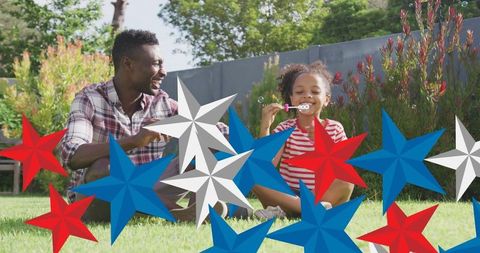 Father and Daughter Celebrating American Patriotism Outdoors
