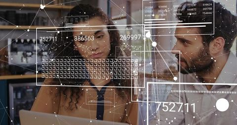 Colleagues Collaborating with Augmented Reality Data Overlay on Laptop Screen