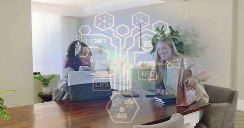 Businesswomen collaborating at home table with holographic digital network overlay and nfc