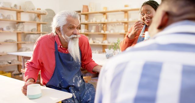 Senior Man Enjoys Pottery Class with Friends - Download Free Stock Images Pikwizard.com