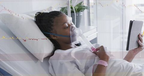 Young Patient Receiving Oxygen and Nebulizer Respiratory Therapy While Using Tablet in Ward