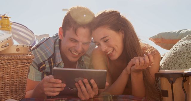 Happy Couple Relaxing Outdoors on Summer Day Watching Tablet - Download Free Stock Images Pikwizard.com