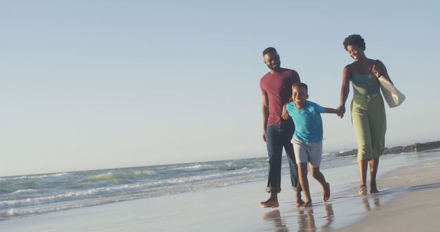 Happy Family Walking on Beach Holds Hands, Enjoying Vacation - Download Free Stock Images Pikwizard.com