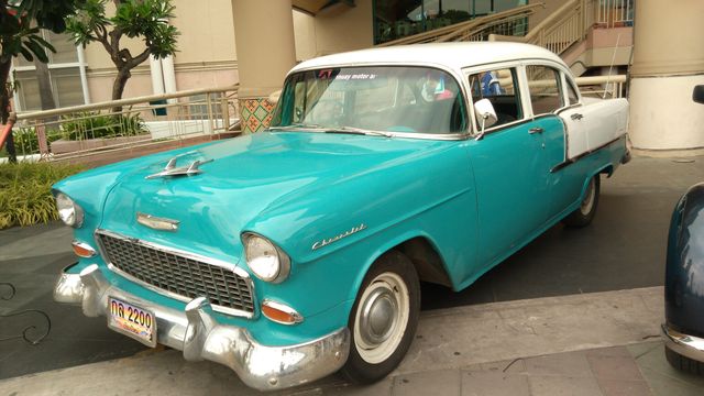 Vintage Teal and White Classic Car Parked Outdoors at Building Entrance - Download Free Stock Photos Pikwizard.com