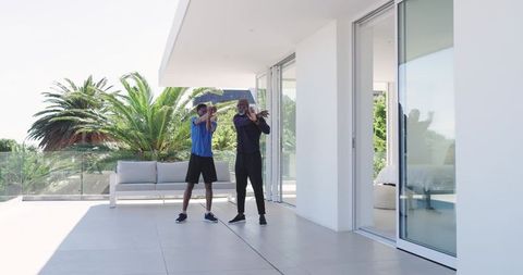African American Friends Stretching on Modern Balcony with Scenic View