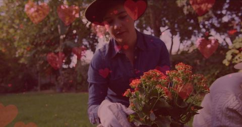 Caucasian Woman Gardening with Heart Overlay Emphasis on Love