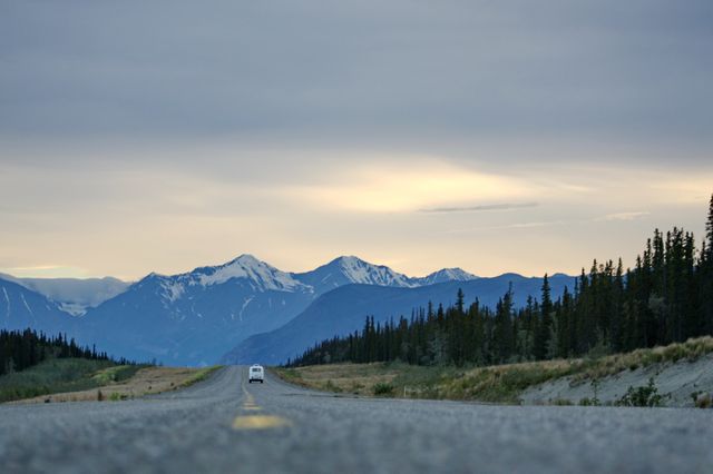 Car on Straight Road Amidst Majestic Mountain Landscape - Download Free Stock Photos Pikwizard.com