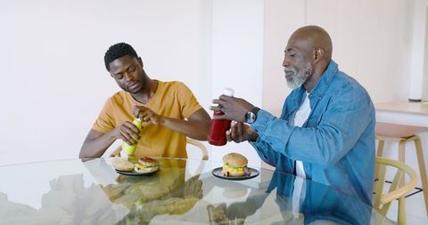 African American Men Preparing Burgers in Modern Kitchen