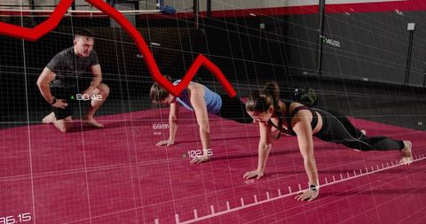 Group holding planks with wearable analytics and coach monitoring performance metrics