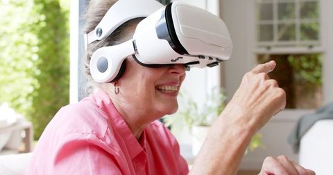 Senior Woman Enjoying Virtual Reality Experience at Home