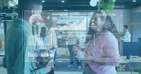 Team collaborating over holographic data dashboard in modern open office workspace