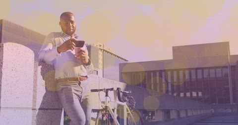 Professional Man with Bicycle Using Smartphone in Urban Setting