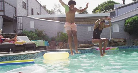 Group of Friends Jumping into Swimming Pool at Party - Download Free Stock Images Pikwizard.com