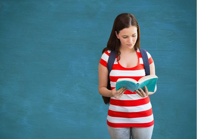 Student with backpack holding a book against blue background