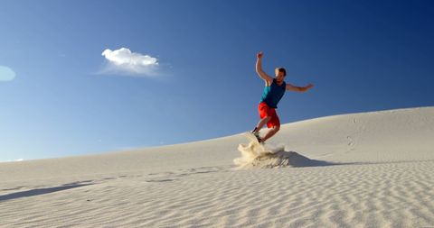 Man Leaping on Sand Dune Embrace Adventure in Nature