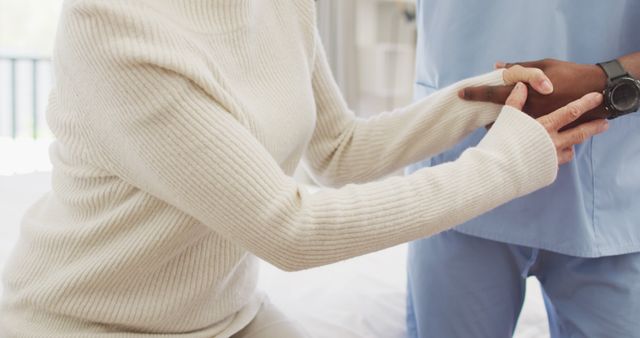 Image of midsection of african american male doctor taking care of caucasian senior woman - Download Free Stock Photos Pikwizard.com