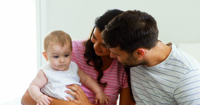 Parents enjoy bonding with their baby at home, creating a loving and caring environment. Perfect for articles on family life, parenting tips, childhood development, and advertising family-related products.