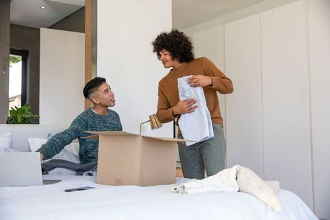 Friends Enjoying Time Unpacking After Move at Home