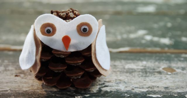 Adorable Pinecone Owl Craft on Wooden Surface - Download Free Stock Images Pikwizard.com