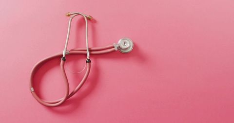 Pink Stethoscope Coiling on Monochrome Pink Background for Medical Branding and Wellness
