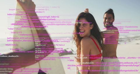 Smiling surfer woman in red swimsuit with friends on sunny beach with digital code overlay