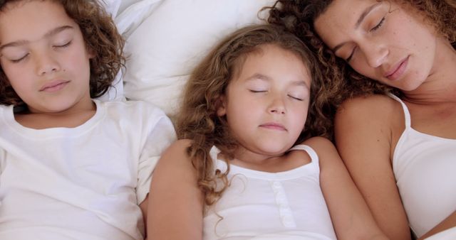 Family sleeping on bed together at home - Download Free Stock Photos Pikwizard.com