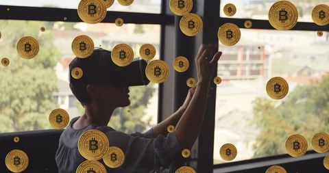 Person Wearing VR Headset with Virtual Bitcoins in Modern Office