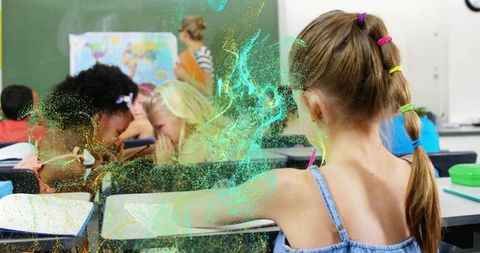 Girl with braided ponytail sitting at classroom desk whispering with classmates, map and glitter ove