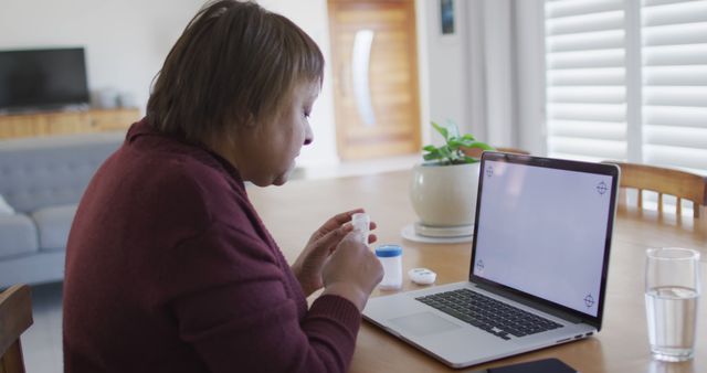 Older Woman Taking Medicine While Using Laptop at Home - Download Free Stock Images Pikwizard.com