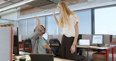 Colleagues Brainstorming Enthusiastically in Modern Office